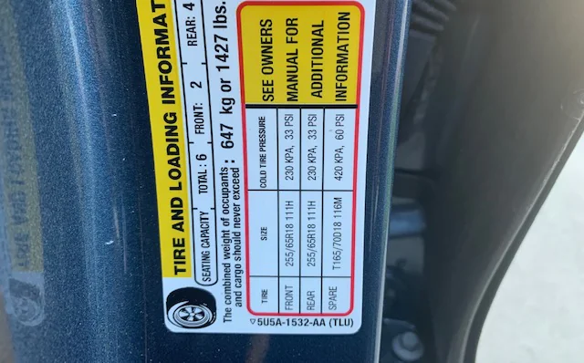 How do I find the correct tire pressure for my car?